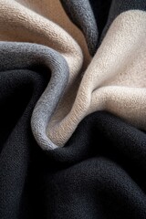 Fototapeta premium Intricate draping of soft cashmere fabric showcases sculptural folds, enhanced by sharp lighting and deep black contrasts, creating an avant-garde aesthetic ideal for fashion or interior design