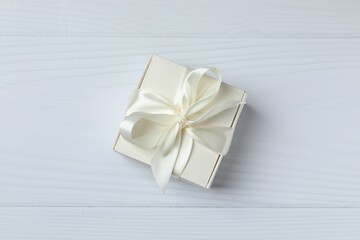 Beautiful gift box tied with bow on white background 