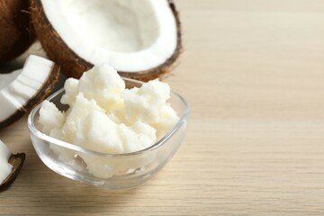 Jar of coconut oil on wooden background
