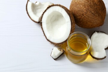 Jar of coconut oil on wooden background