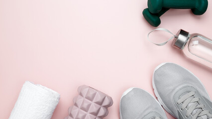 Healthy lifestyle. Fitness accessories including sneakers, dumbbells, foam roller for Myofascial...