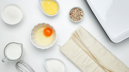 Baking Crinkle Cake, near dish with ingredients, phyllo dough, egg, butter, nuts, milk