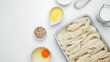 Crinkle Cake baking, filo dough in a baking dish near milk, eggs, butter, butter, sugar