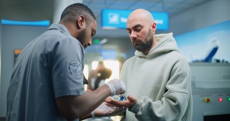 Airport Terminal: African American Security Officer Conducts TSA Hand Swab Screening with Brush to...