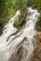 Fototapeta premium Wasserfall nach einem Starkregen am Walchensee bei Urfeld in den deutschen Alpen. 