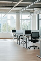 Office workspace featuring modern desks and chairs with natural lighting, designed for productivity and collaboration in a corporate environment.