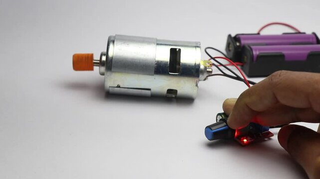 DC motor connected to battery source and controlled by speed controller and the shaft rotates when the controller knob is turned
