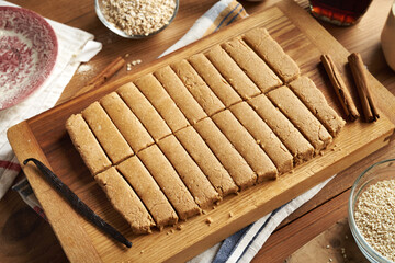 Homemade healthy bars made with whey protein powder, oat flakes, sesame tahini, maple syrup, cinnamon and vanilla
