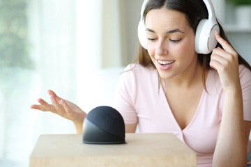 Woman talking to smart speaker asking for music