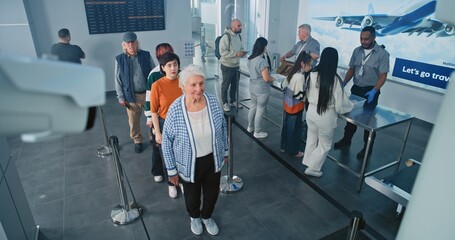 Security Checkpoint in Airport Terminal: Queue of Diverse People, Tourists on TSA Screening...