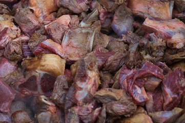 Meat is chopped into pieces. Beef for food. Texture. Preparation. Close view. No people