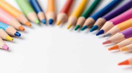 Naklejka premium Colorful wooden pencils arranged in a semi-circle on a white background in bright studio light.