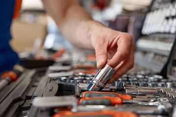 Foreman checking socket wrenches in tool box at hardware store