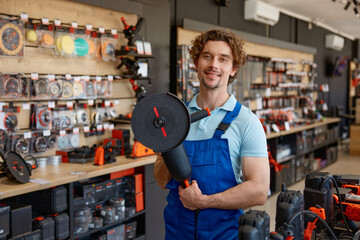 Worker testing big angle grinder at hardware store