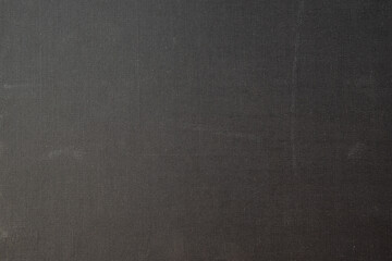 Surface of worn black old cardboard sheet.
