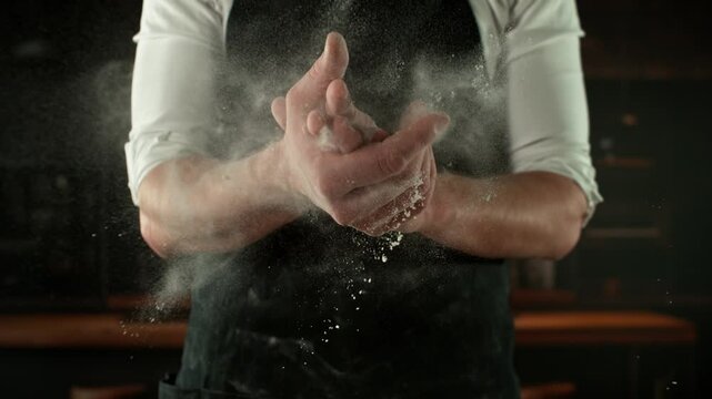 Super Slow Motion Chef Clapping Hands with Flour . Filmed on High Speed Cinema Camera, 1000 fps . Closeup of Bread or Pizza Dough Preparation