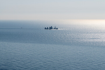High-angle view of the rocks on the sunlight-reflected sea