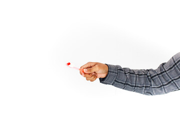 Promoting oral hygiene: A hand holding a toothbrush on a clean backdrop