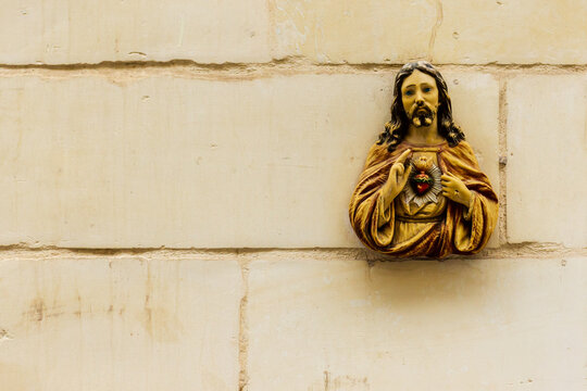 Sacred Heart Of Jesus Religious Statue On A Textured Wall Background