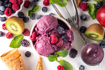 Homemade fruit and berry sorbet ice cream, portioned bowl with healthy fruit and berry yogurt...