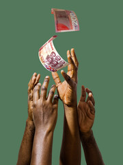 Many black African hands reaching out for 200 Ghanaian Cedi notes money over green background....