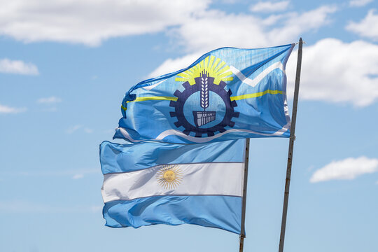 Argentinian and Chubut province flag waving over blue sky background