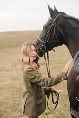 Elegant Woman With Horse Outdoors on a Countryside Field in Autumn