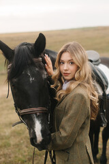 Fototapeta premium Young Woman Bonding with Her Horse in a Scenic Outdoors Setting