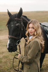 Fototapeta premium Beautiful Equestrian Woman With Horse in a Scenic Countryside Landscape
