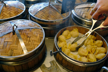 Dim sum and dumpling  buffet in a restaurant. Steamer baskets.