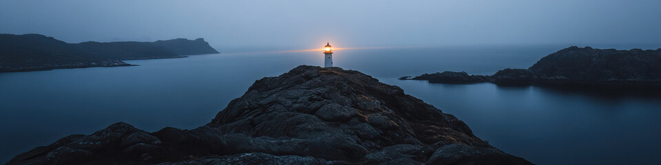 Fototapeta premium Lighthouse on Coastal Outcrop at Dusk