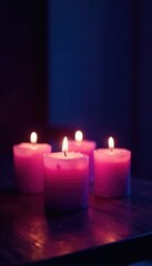 Soft purple glow from four candles on a wooden table, mystery lights, darkness