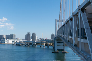 Fototapeta premium Rainbow bridge close up under the blue sky in Tokyo, Japan