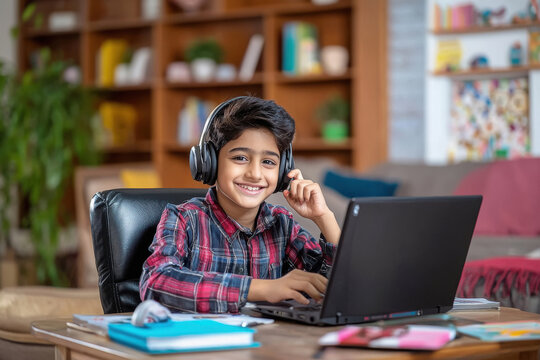 indian schoolboy studying on laptop