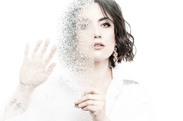 Portrait of a woman with dark hair, dressed in a white shirt, done in a high key.