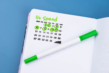 No Spend Challenge planner tracker, with checkmarks calendar marking successful no-spend days. Concept of personal finance, budgeting, financial discipline, frugality, and mindful spending habits