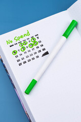 No Spend Challenge planner tracker, with checkmarks calendar marking successful no-spend days. Concept of personal finance, budgeting, financial discipline, frugality, and mindful spending habits