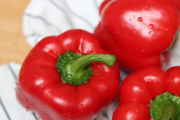 Red bell peppers close up. Shallow depth of field. Fresh vegetables on a table. 