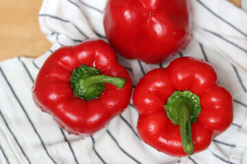 Red bell peppers close up. Shallow depth of field. Fresh vegetables on a table. 
