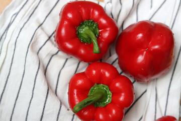 Red bell peppers close up. Shallow depth of field. Fresh vegetables on a table. 