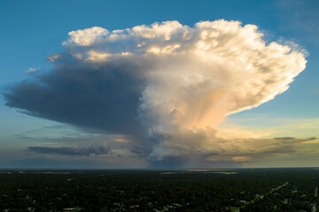 Rainstorm shower over Florida rural town in humid summer season. Rain water pouring down from stormy clouds
