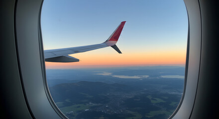 Stunning Aerial View at Sunset from Airplane Window: Wing, Landscape, and Golden Hour Sky
