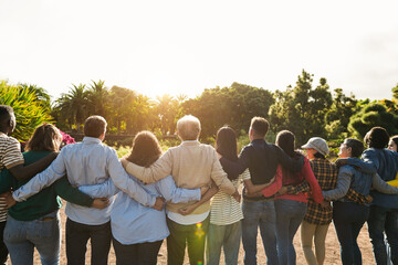 Group of multi generational people hugging each others - Support, multiracial, empowering and diversity concept - Main focus on senior man with white hairs