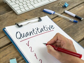 Adult man writing quantitative checklist on clipboard at desk