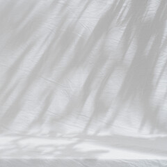 Table on bright brown wall background. Composition with tree shadow on the wall. Background for presentation, branding products, cosmetics, food or jewellery.	