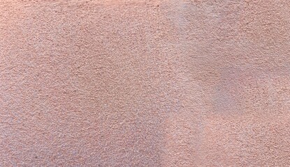 Fototapeta premium Rough Textured Plaster Wall Surface with Subtle Pinkish Beige Tones for Grunge and Vintage Backgrounds
