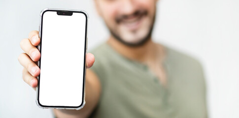 Man holds smartphone with blank white screen for mockup