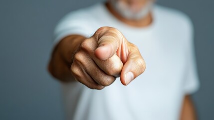A close-up of an adult hand pointing at the camera, that invites viewers into a personal connection while conveying an assertive presence and emotional engagement with the viewer.
