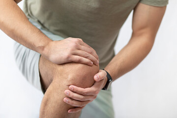 The man grabbed his knee due to severe pain