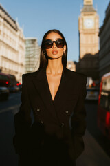 Obraz premium Fashionable woman in black blazer near big ben